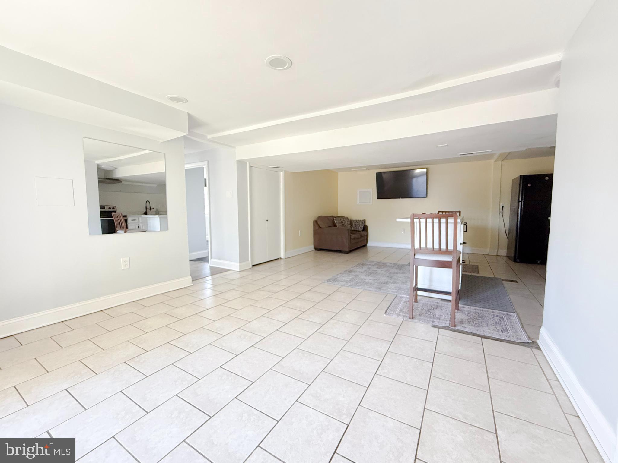 11601 Veirs Mill Road Wheaton, MD 20902 - Photo 17 of 30 a view of a livingroom with a chair and a potted plant