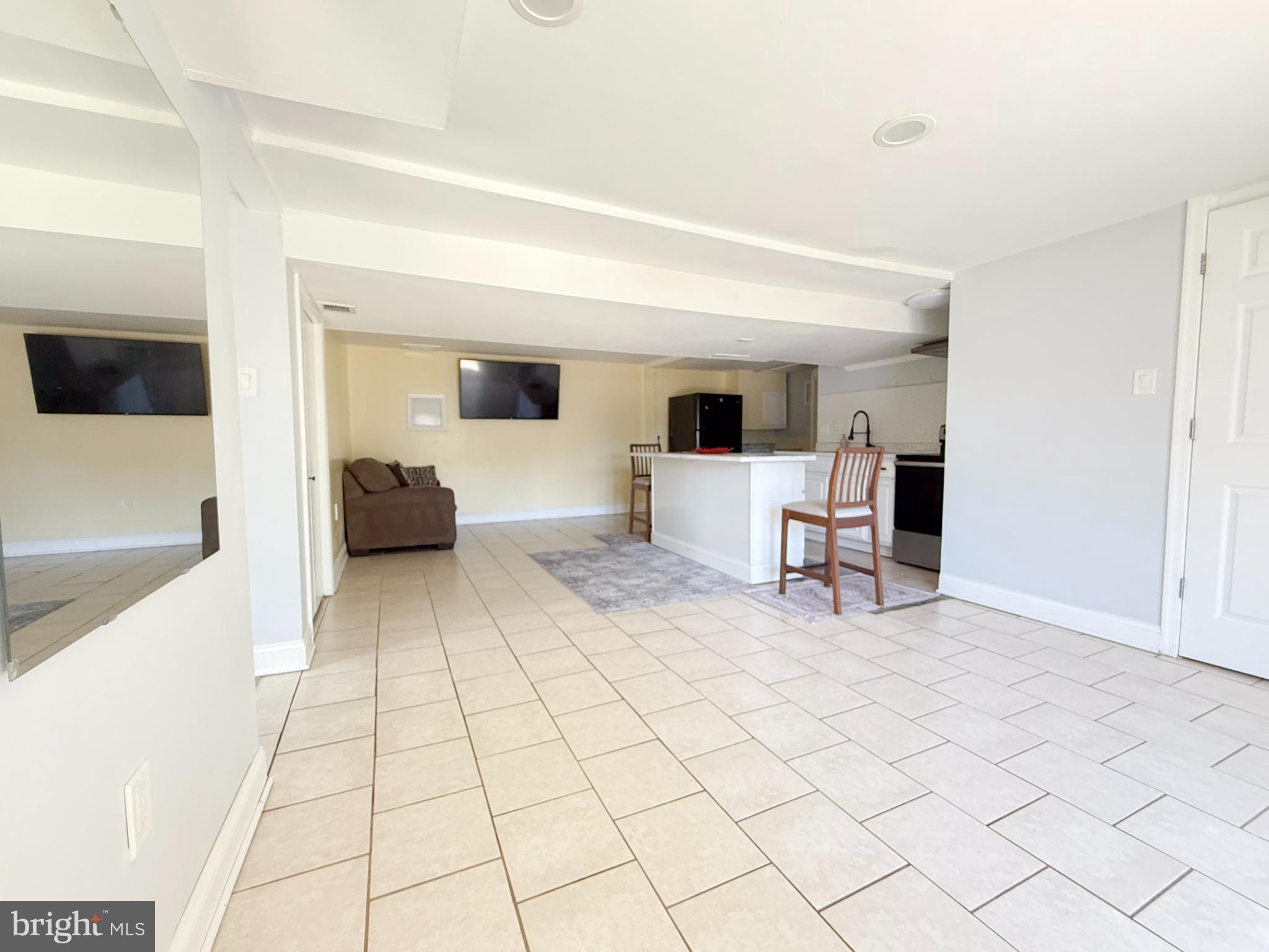 11601 Veirs Mill Road Wheaton, MD 20902 - Photo 18 of 30 a living room with furniture and a flat screen tv