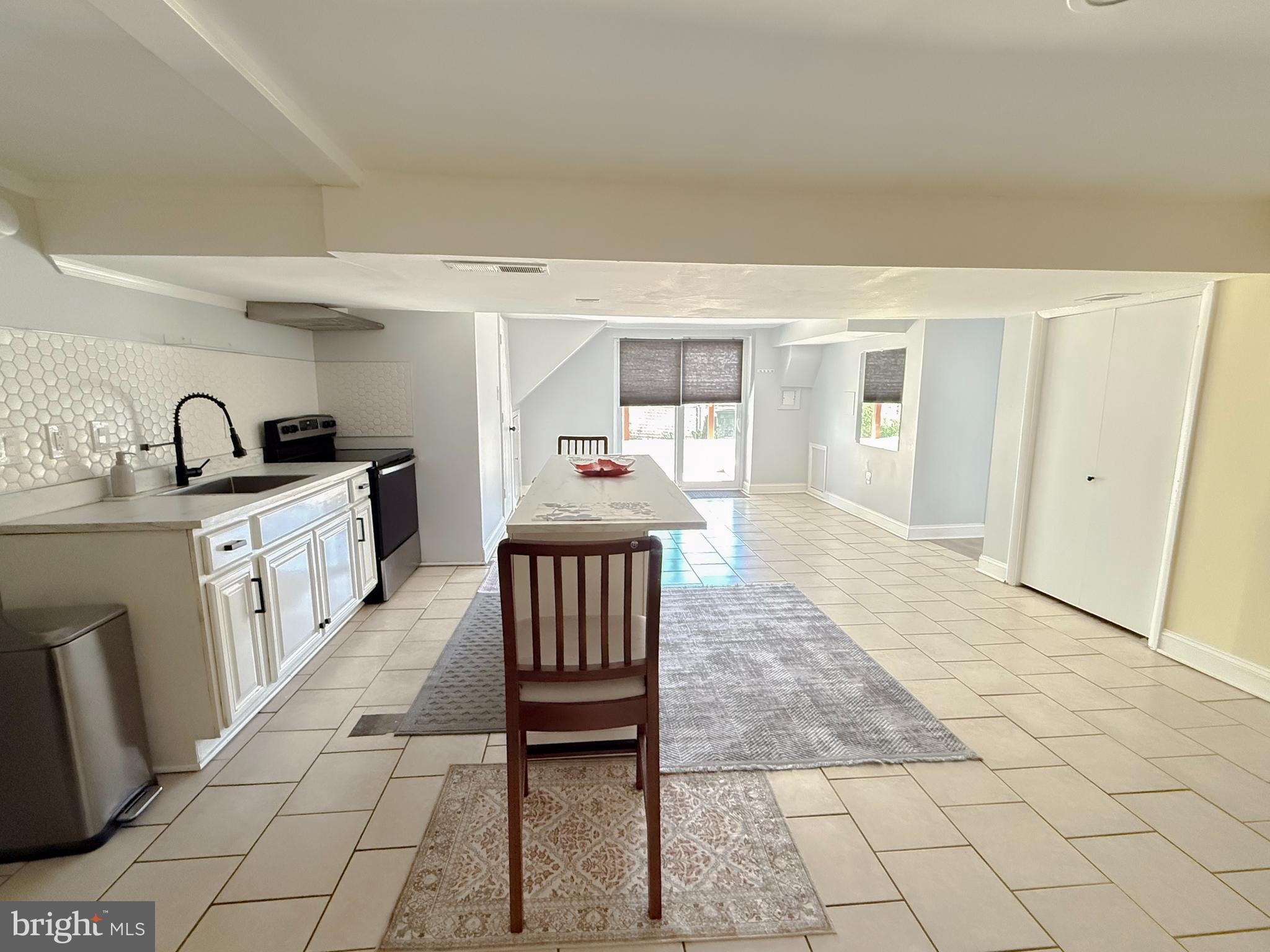 11601 Veirs Mill Road Wheaton, MD 20902 - Photo 24 of 30 a kitchen with granite countertop a sink and a stove top oven