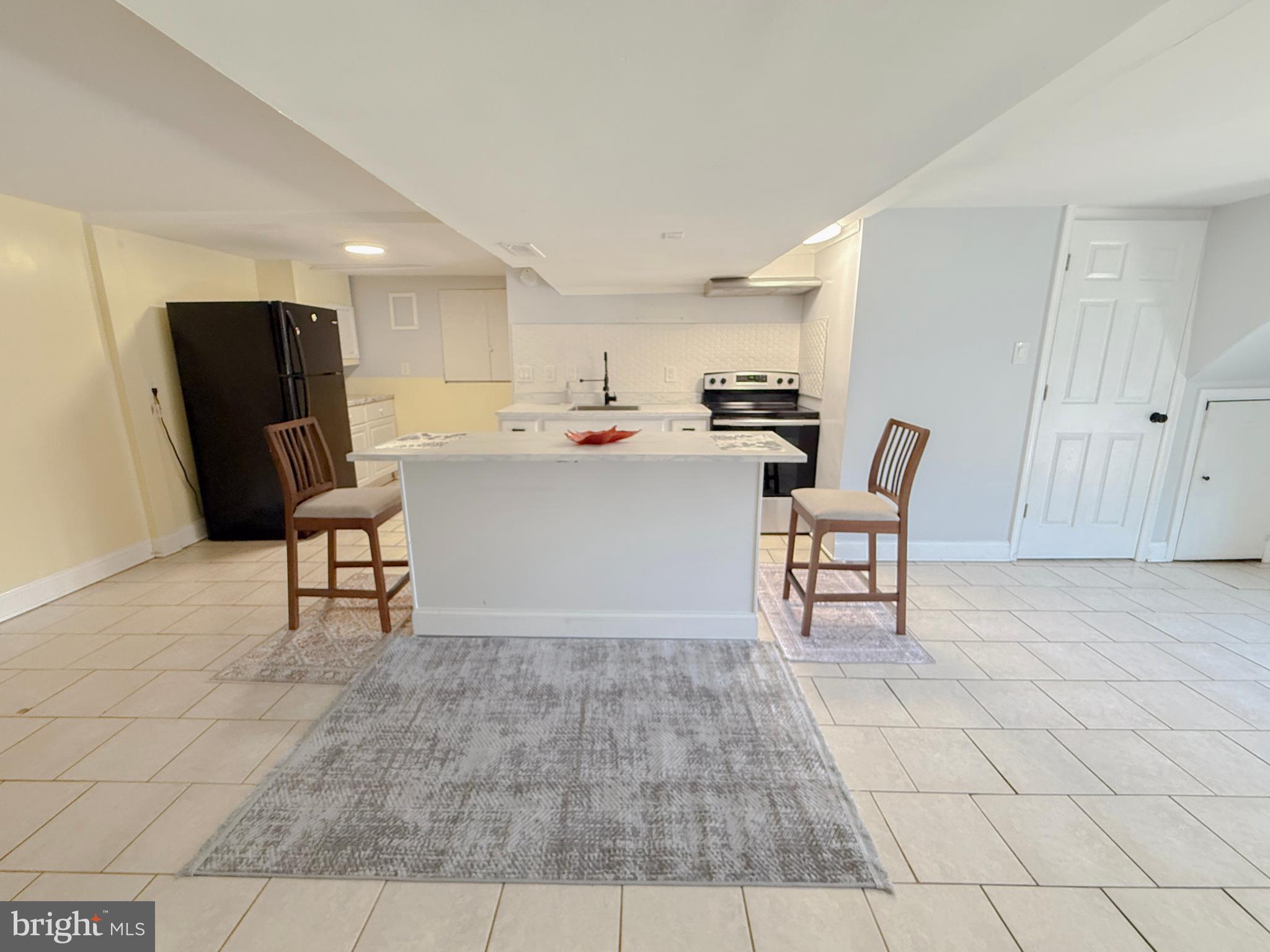 11601 Veirs Mill Road Wheaton, MD 20902 - Photo 26 of 30 a living room with furniture and a rug