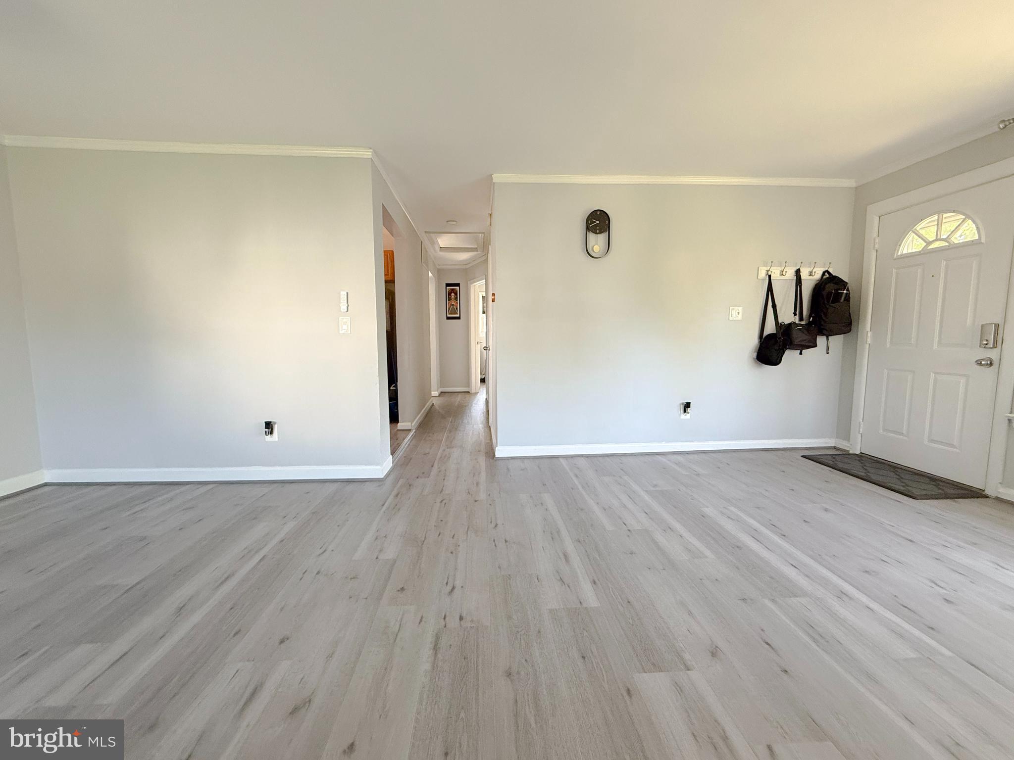 11601 Veirs Mill Road Wheaton, MD 20902 - Photo 6 of 30 an empty room with wooden floor and windows