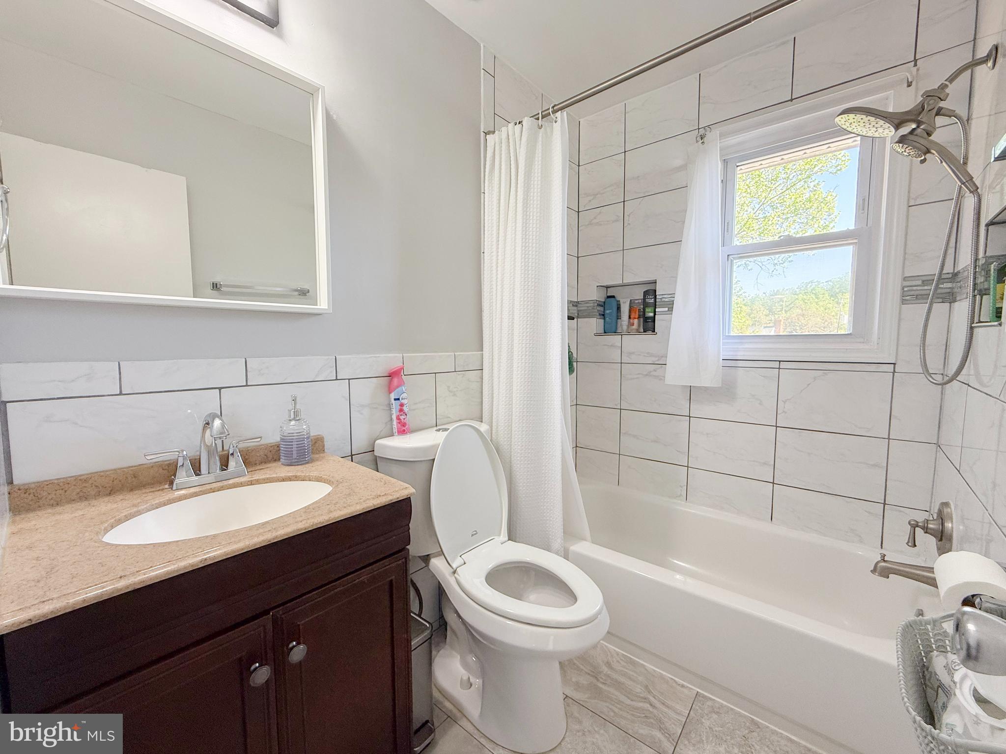 11601 Veirs Mill Road Wheaton, MD 20902 - Photo 10 of 30 a bathroom with a sink a toilet and bathtub
