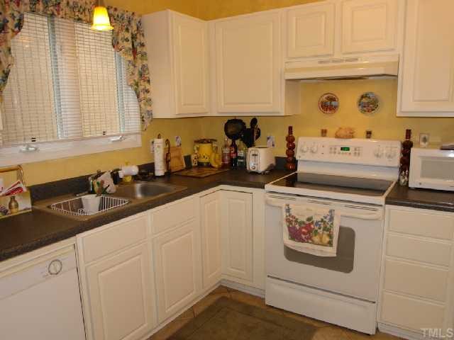 4301 Southwind Drive Raleigh, NC 27613 - Photo 4 of 12 a kitchen with a sink and cabinets