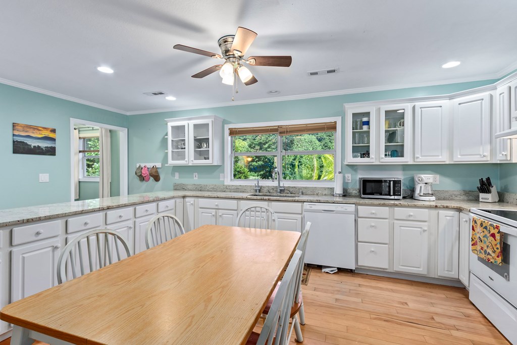615 Little Ranger Road Murphy, NC 28906 - Photo 19 of 97 a kitchen with stainless steel appliances granite countertop a stove top oven a sink a dining table and chairs