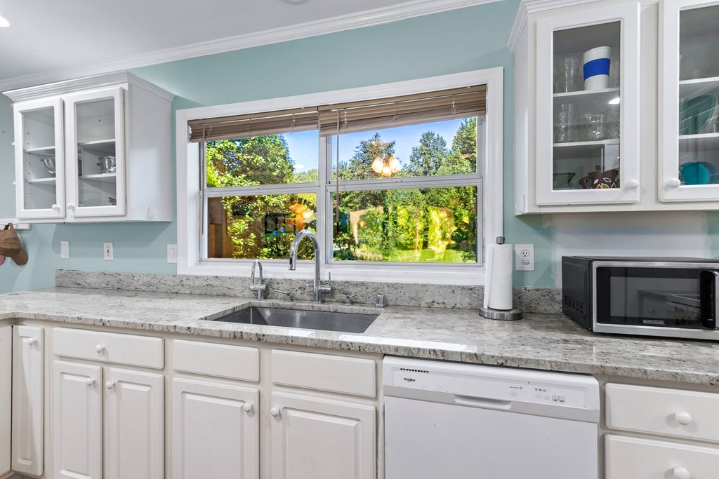 615 Little Ranger Road Murphy, NC 28906 - Photo 20 of 97 a kitchen with granite countertop white cabinets and a window