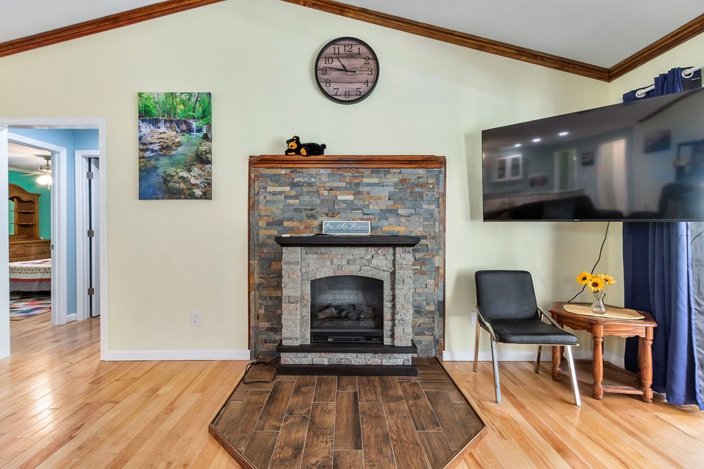 615 Little Ranger Road Murphy, NC 28906 - Photo 26 of 97 a living room with a fireplace and a wooden floor