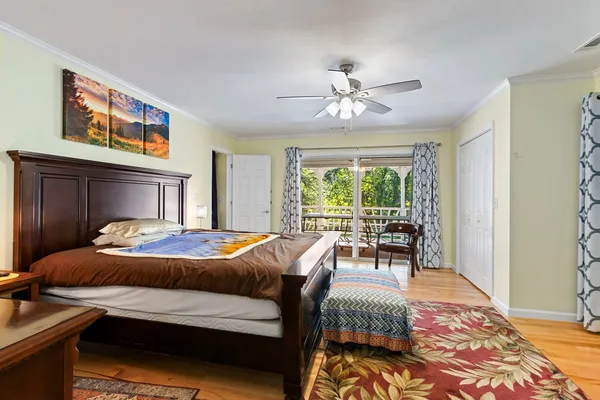a dining room with furniture water view and a floor to ceiling window