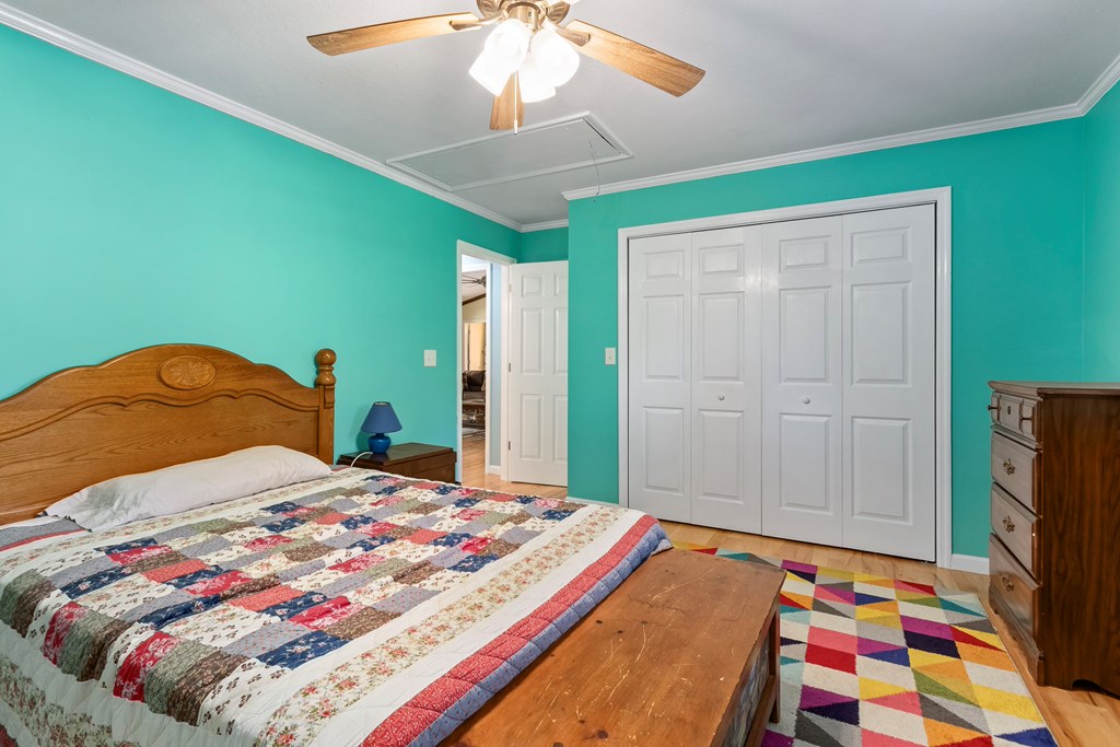 615 Little Ranger Road Murphy, NC 28906 - Photo 46 of 97 a bedroom with a bed and a chandelier