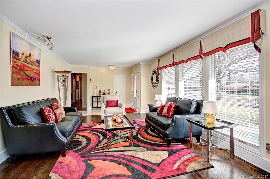 918 Lansdowne Road Charlotte, NC 28270 - Photo 12 of 24 a living room with furniture and a floor to ceiling window