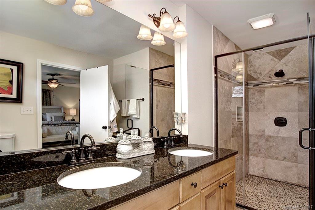 918 Lansdowne Road Charlotte, NC 28270 - Photo 15 of 24 a bathroom with a granite countertop sink mirror and shower