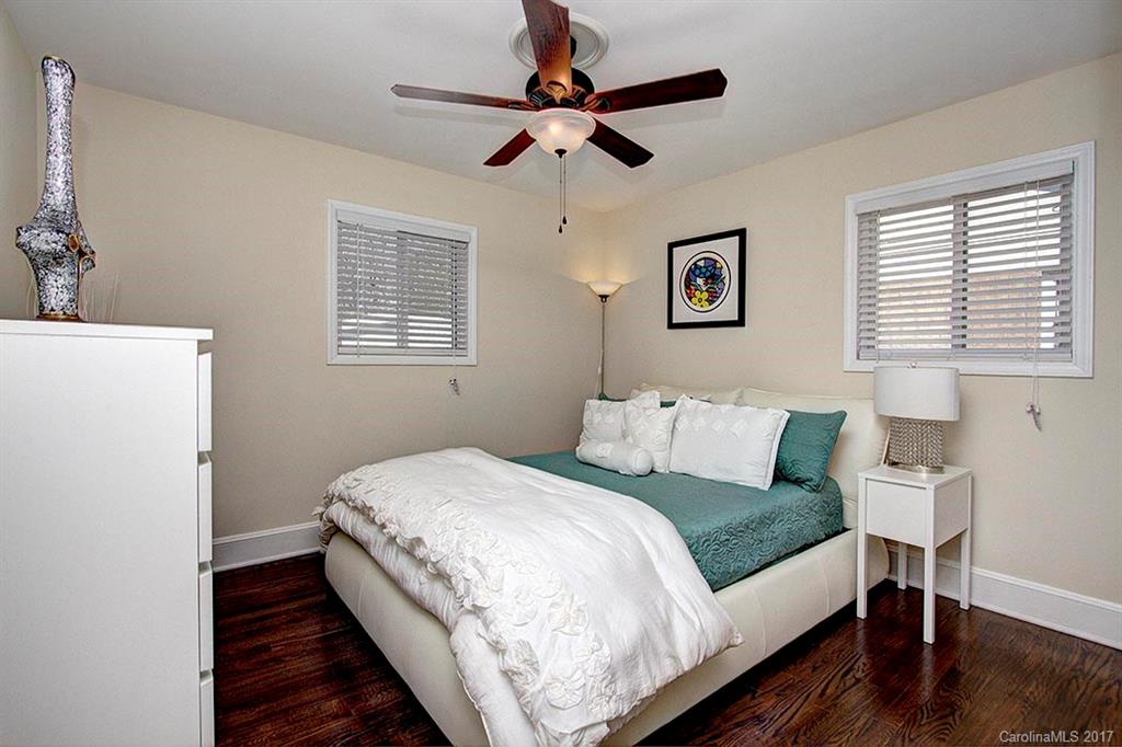 918 Lansdowne Road Charlotte, NC 28270 - Photo 16 of 24 a bed room with a bed and a lamp