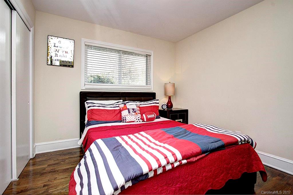 918 Lansdowne Road Charlotte, NC 28270 - Photo 18 of 24 a bedroom with a bed and wooden floor