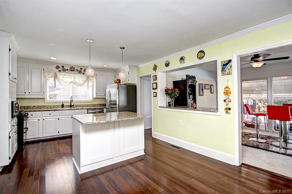 918 Lansdowne Road Charlotte, NC 28270 - Photo 5 of 24 a large kitchen with stainless steel appliances granite countertop a refrigerator a stove and a wooden floors