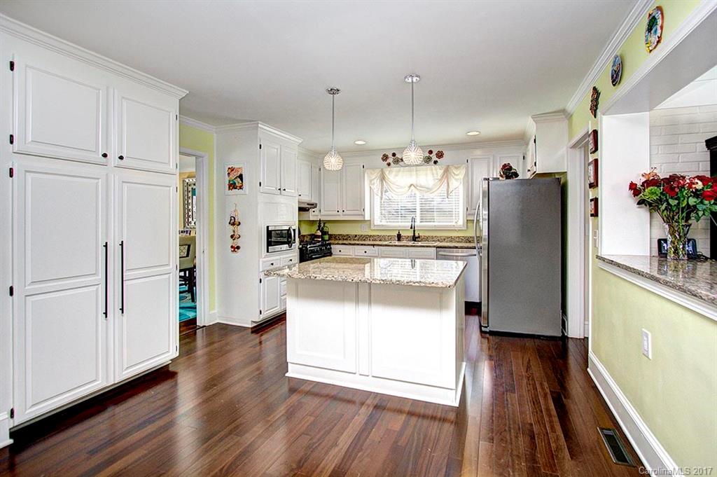 918 Lansdowne Road Charlotte, NC 28270 - Photo 6 of 24 a kitchen with stainless steel appliances a refrigerator a stove a sink cabinets and wooden floor