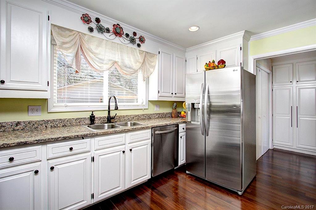 918 Lansdowne Road Charlotte, NC 28270 - Photo 7 of 24 a kitchen with granite countertop a sink stainless steel appliances and cabinets