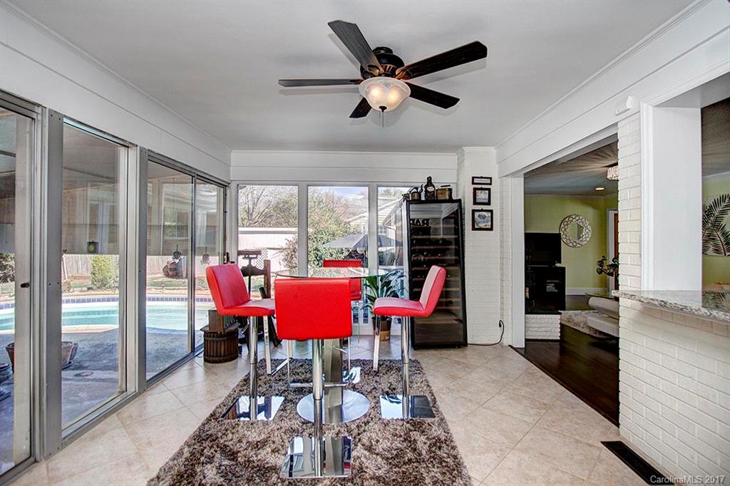 918 Lansdowne Road Charlotte, NC 28270 - Photo 10 of 24 a dining room with furniture a flat screen tv and a large window