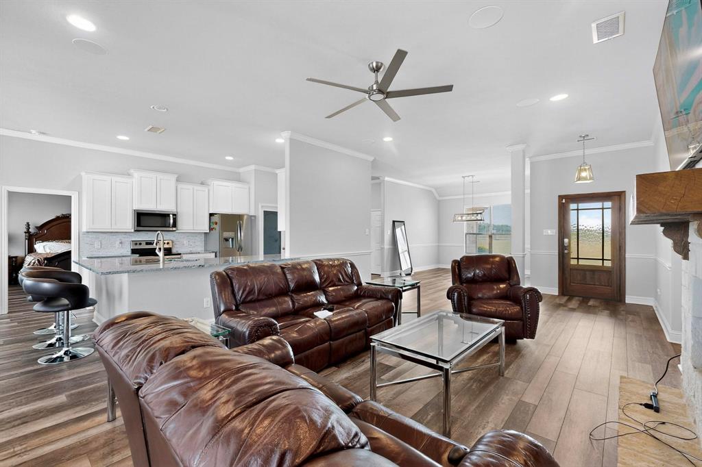 634 Gant Road Sherman, TX 75090 - Photo 11 of 40 Living area with dark wood-style flooring, crown molding, a ceiling fan, and recessed lighting