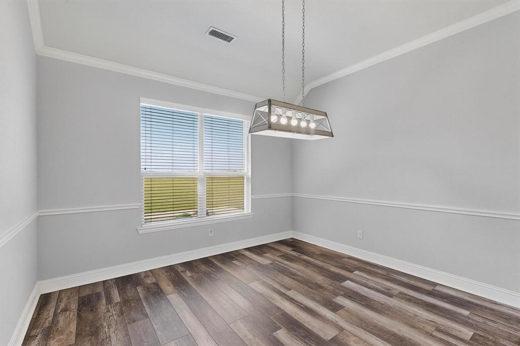 634 Gant Road Sherman, TX 75090 - Photo 14 of 40 Unfurnished dining area featuring crown molding and dark wood finished floors