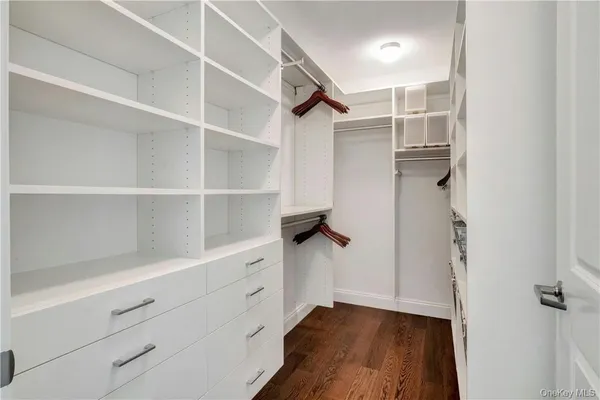 a view of walk in closet with empty racks
