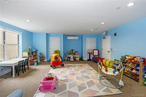 a living room with furniture and gym equipment