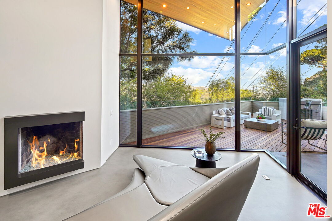 7187 Macapa Drive Los Angeles, CA 90068 - Photo 15 of 39 a living room with a floor to ceiling window and floor to ceiling window
