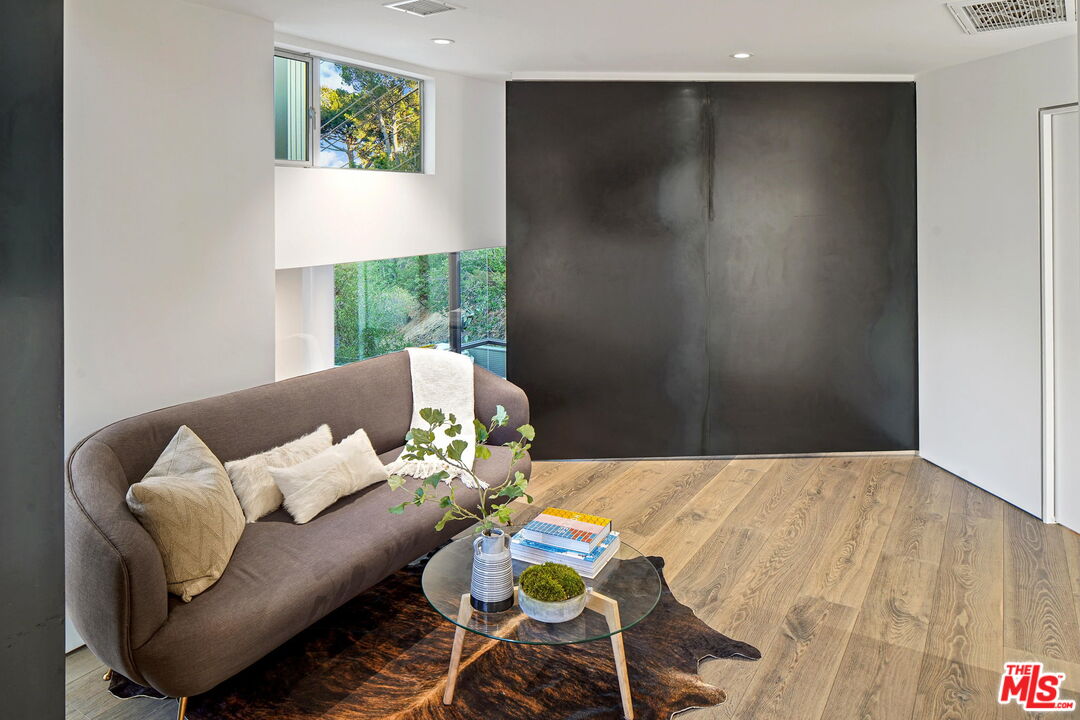 7187 Macapa Drive Los Angeles, CA 90068 - Photo 19 of 39 a balcony with furniture and painting on the wall