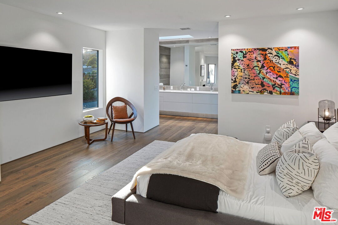 7187 Macapa Drive Los Angeles, CA 90068 - Photo 24 of 39 a bedroom with a bed and a flat screen tv