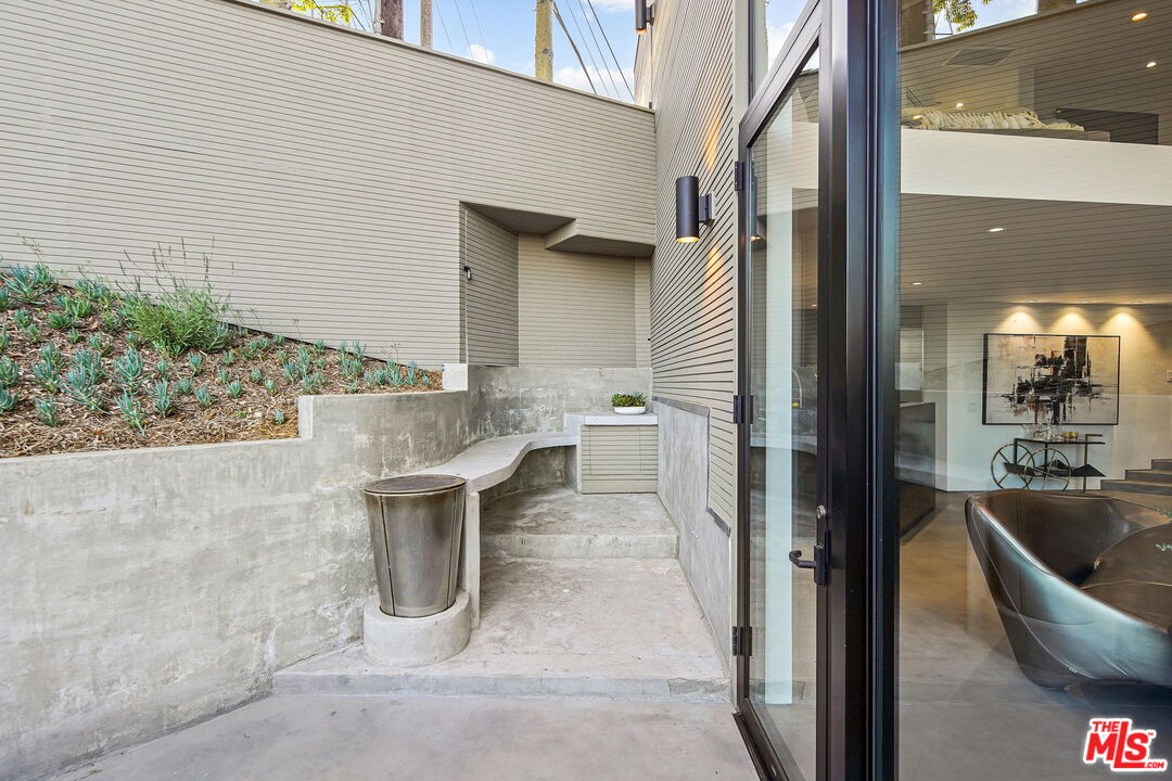 7187 Macapa Drive Los Angeles, CA 90068 - Photo 31 of 39 a view of a patio with couple of chairs and a fountain