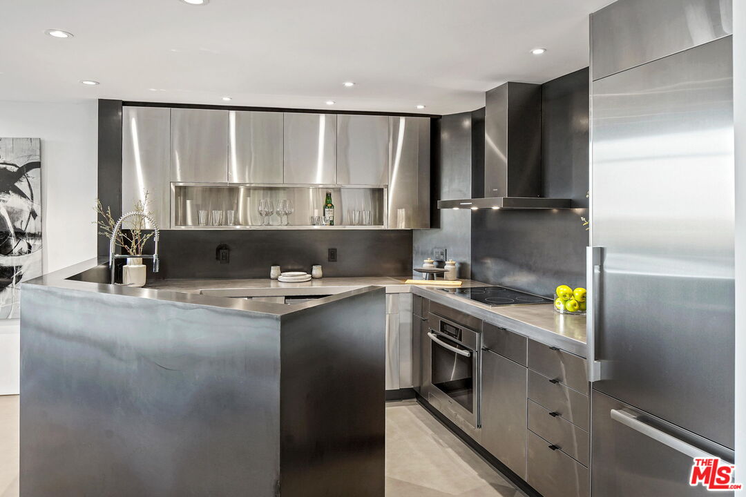 7187 Macapa Drive Los Angeles, CA 90068 - Photo 6 of 39 a kitchen with kitchen island granite countertop a sink and stainless steel appliances