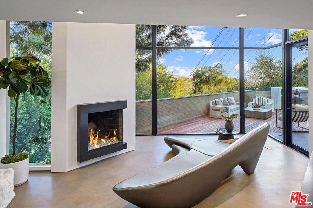 7187 Macapa Drive Los Angeles, CA 90068 - Photo 7 of 39 a living room with furniture and a fireplace