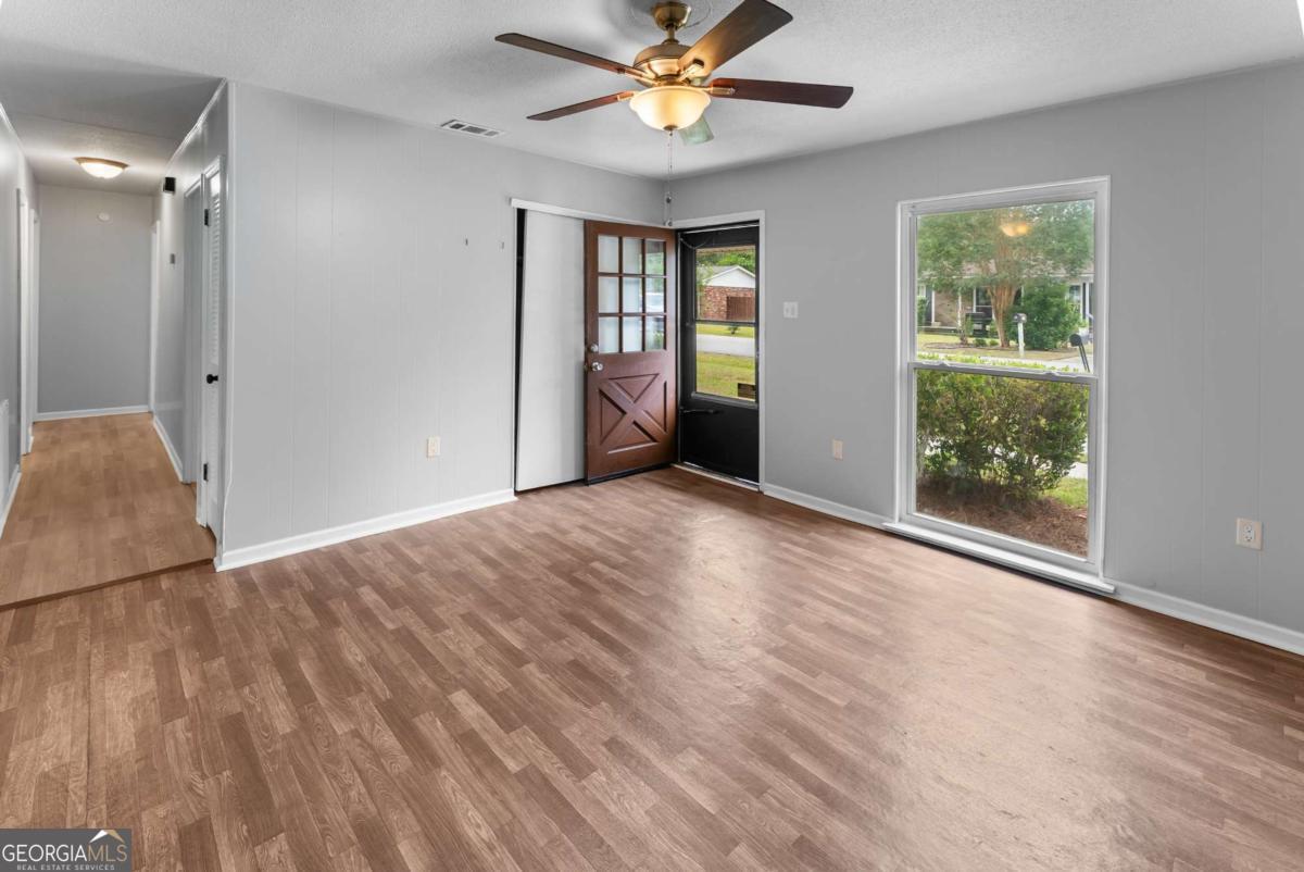 320 West Whatley Street Pooler, GA 31322 - Photo 5 of 34 a view of an empty room with window and wooden floor