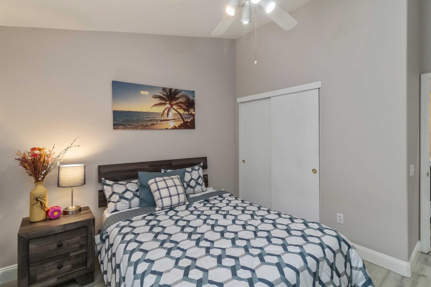 7597 Timberrose Way Roseville, CA 95747 - Photo 21 of 30 a bedroom with a bed and a lamp on dresser