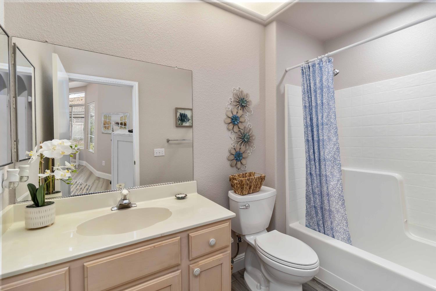 7597 Timberrose Way Roseville, CA 95747 - Photo 23 of 30 a bathroom with a sink a toilet a mirror and shower