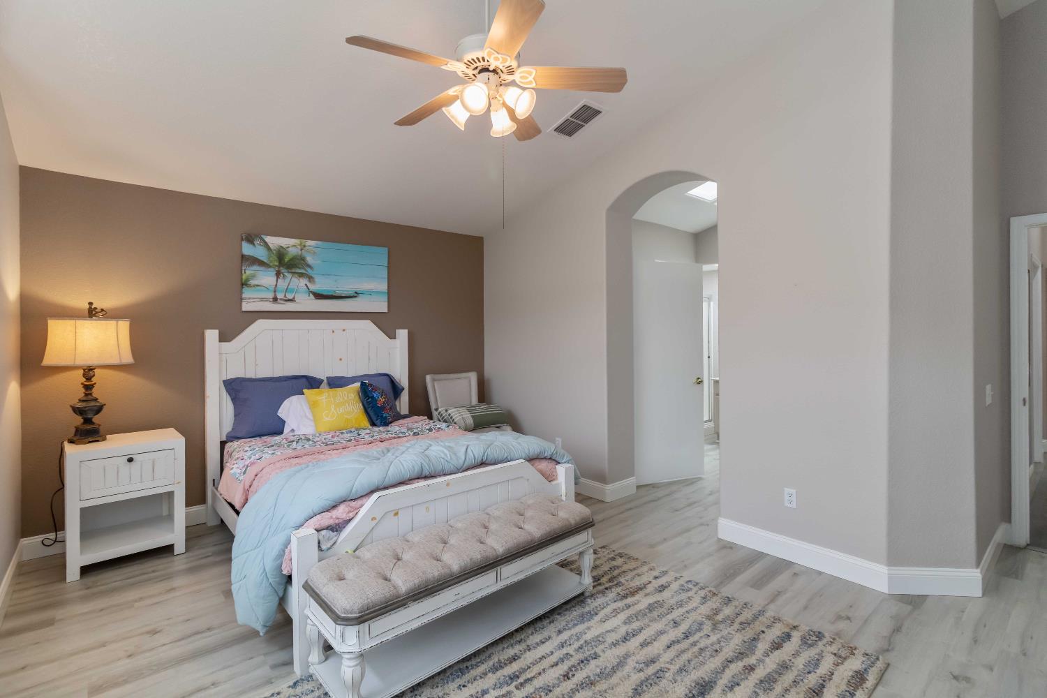 7597 Timberrose Way Roseville, CA 95747 - Photo 25 of 30 a bedroom with a bed and a chandelier