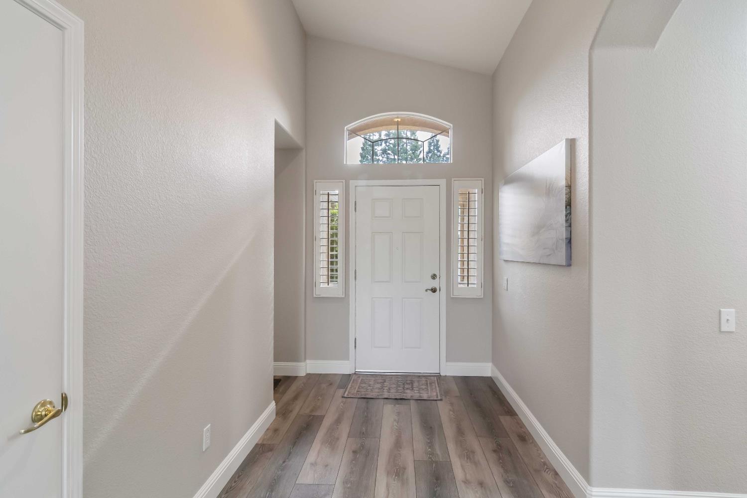 7597 Timberrose Way Roseville, CA 95747 - Photo 5 of 30 a view of a hallway with wooden floor