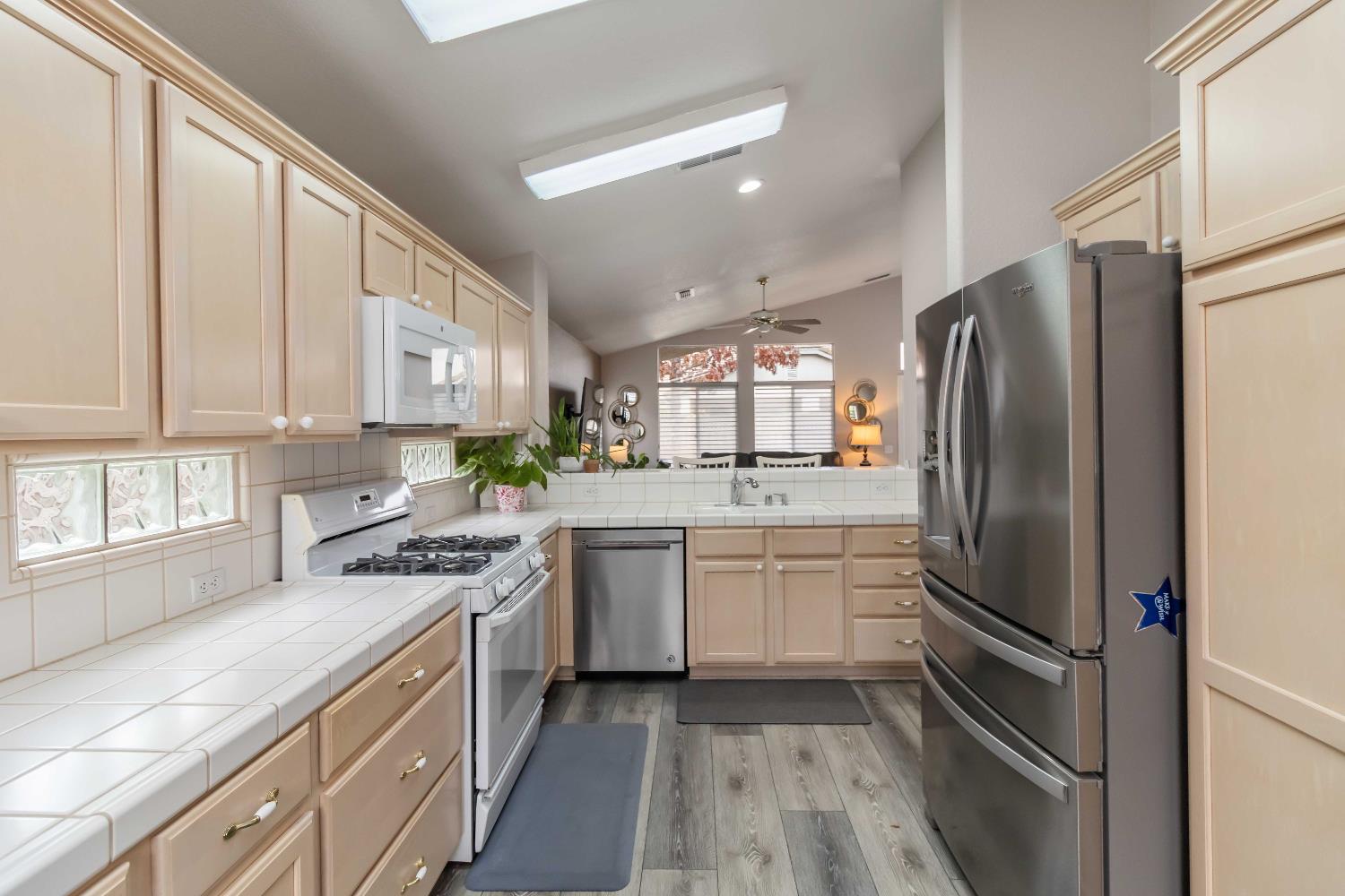 7597 Timberrose Way Roseville, CA 95747 - Photo 10 of 30 a kitchen with stainless steel appliances a refrigerator sink and stove