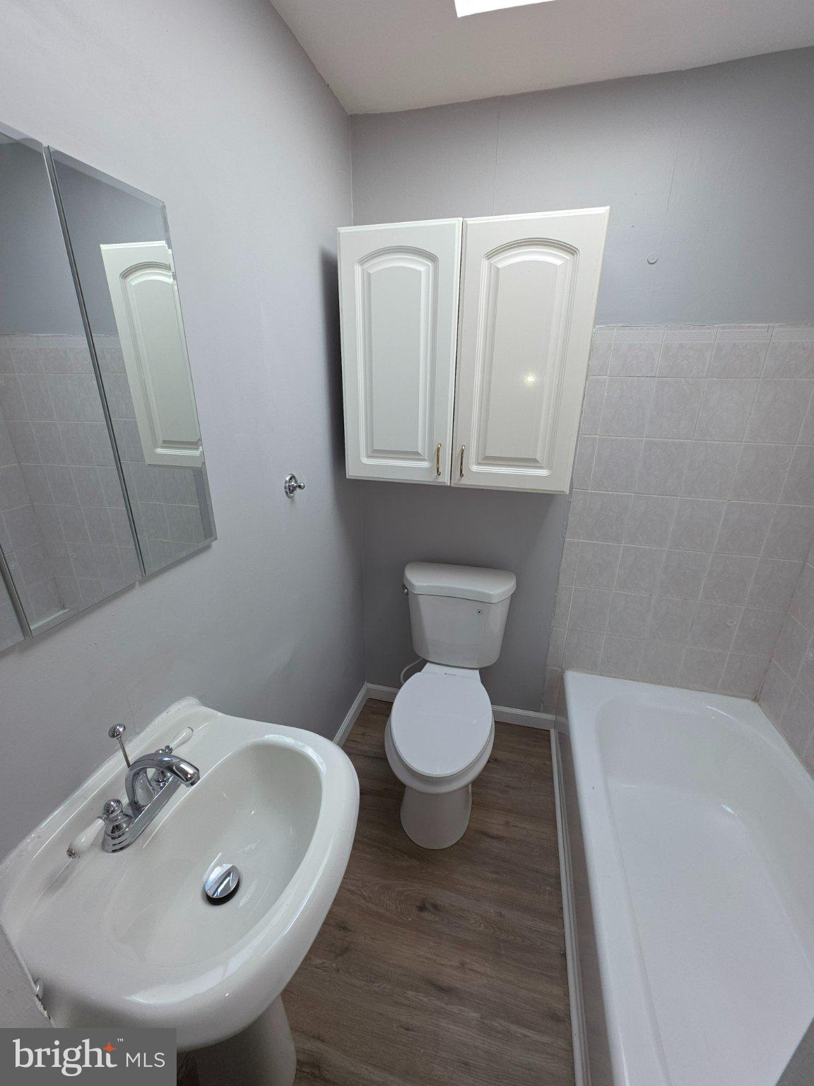 4404 Mountview Road Baltimore, MD 21229 - Photo 6 of 22 a bathroom with a toilet sink and mirror