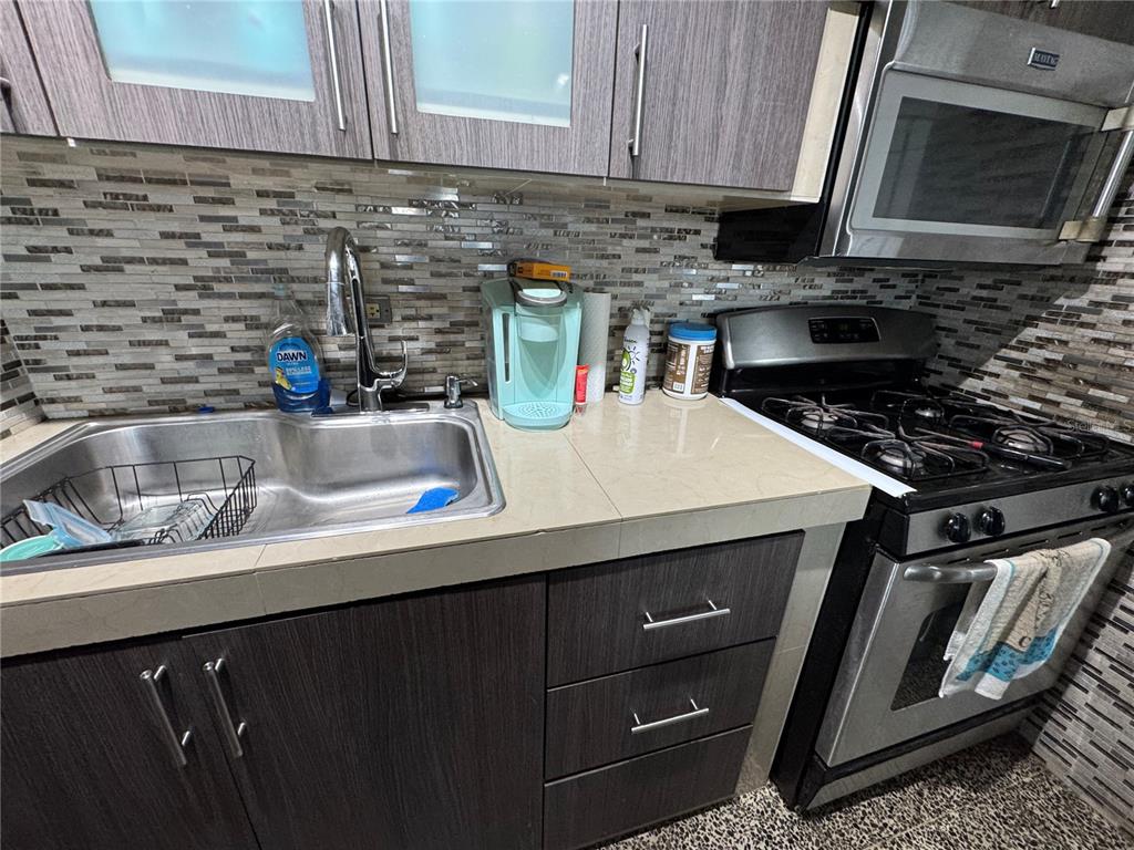 140 Km 38.9 Utuado, Utuado 00641 - Photo 32 of 55 a kitchen with a sink stove and cabinets