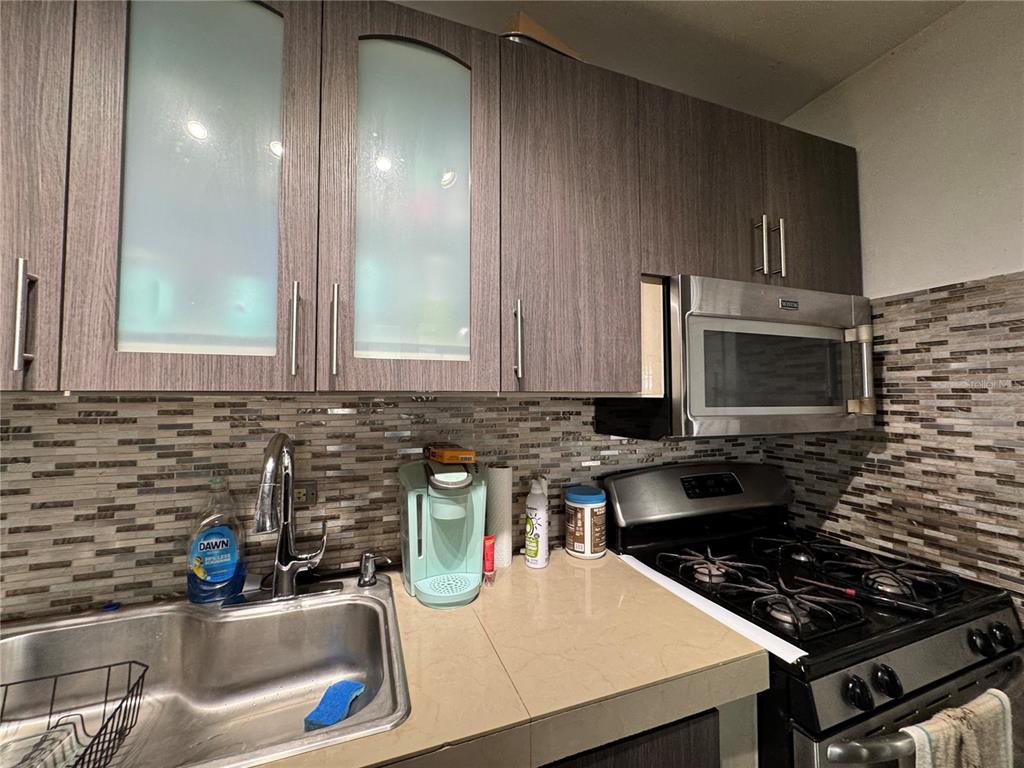 140 Km 38.9 Utuado, Utuado 00641 - Photo 33 of 55 a kitchen with granite countertop a sink and a stove top oven