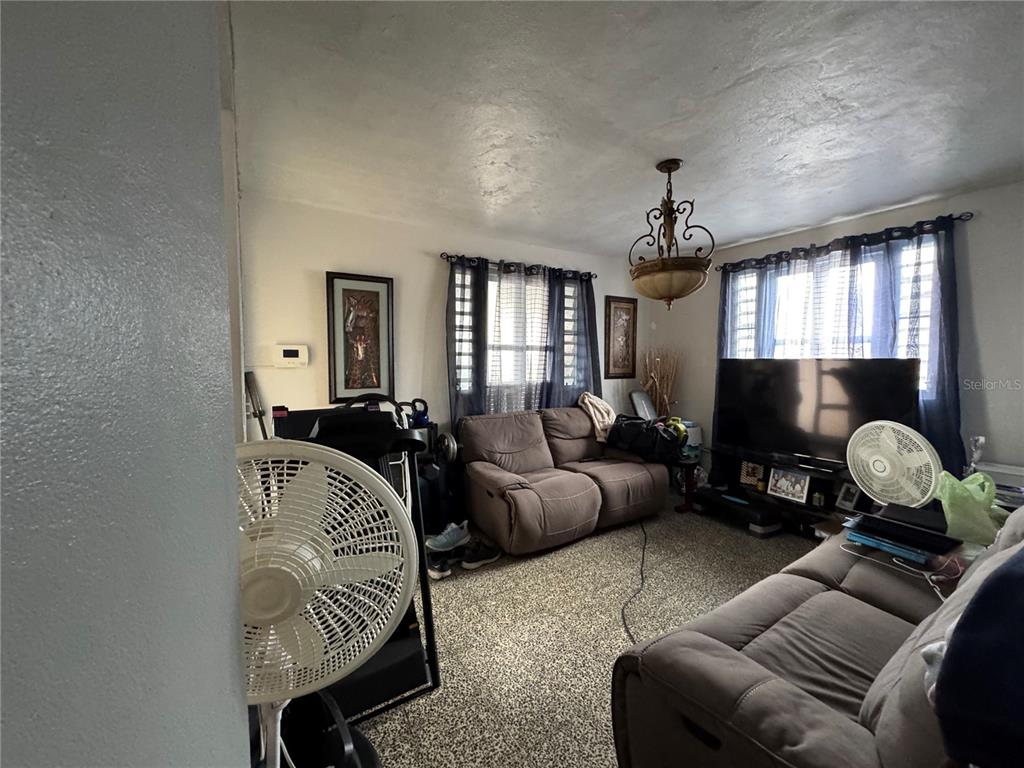 140 Km 38.9 Utuado, Utuado 00641 - Photo 34 of 55 a living room with furniture and a flat screen tv