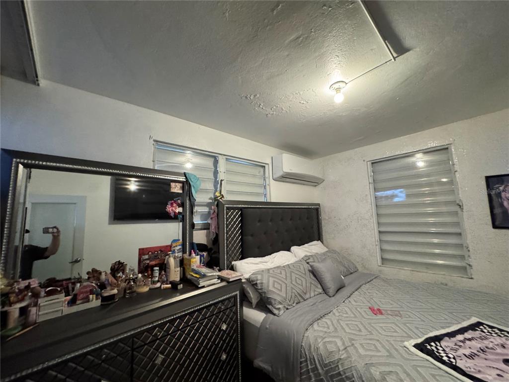 140 Km 38.9 Utuado, Utuado 00641 - Photo 43 of 55 a bedroom with a bed a flat screen tv and gym equipment