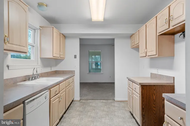 a kitchen with sink cabinets and window