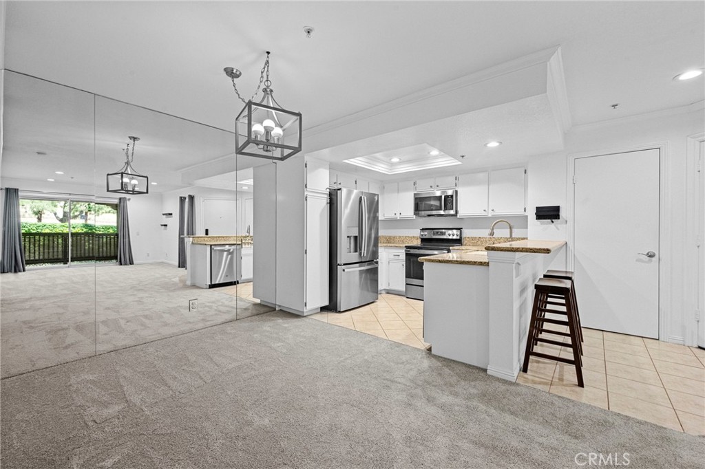 215 South Cross Creek Road, Unit L Orange, CA 92869 - Photo 22 of 50 a view of a kitchen with fridge and wooden floor