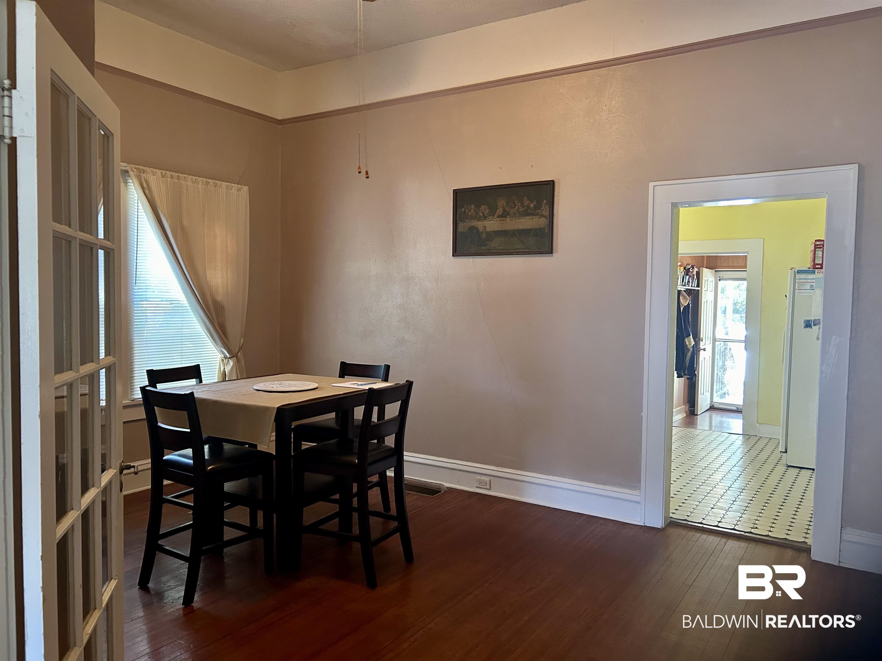 405 North Wasson Avenue Mobile, AL 36612 - Photo 9 of 26 Dining room with dark hardwood flooring, wide baseboards and plenty of natural light