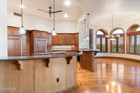 a kitchen with stainless steel appliances granite countertop a stove a sink and a refrigerator