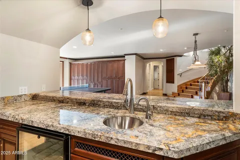 a spacious bedroom with a bed and a large window with balcony view