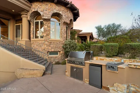 a view of a backyard with table and chairs with wooden fence
