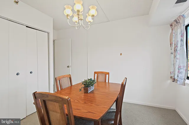 a view of a dining room with furniture and chandelier