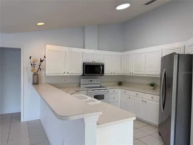 a kitchen with a sink stove and refrigerator