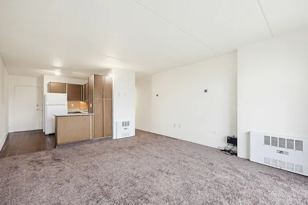 a view of a kitchen with a sink and a refrigerator